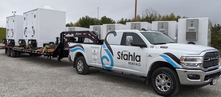 Stahla Rentals truck towing portable restroom trailers.