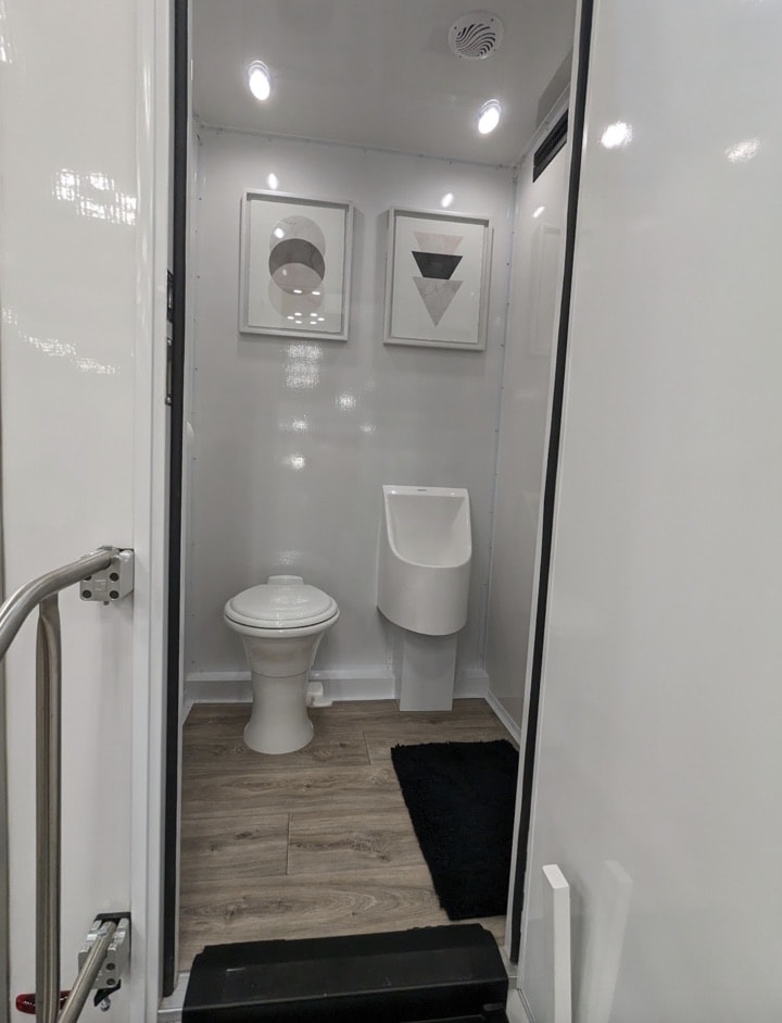 Modern bathroom interior with toilet and urinal.