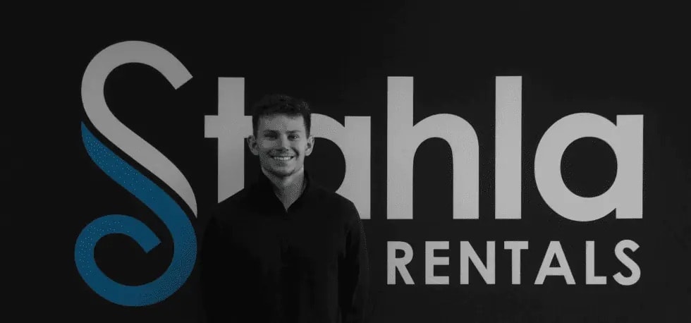 Man smiling beside Stahla Rentals logo