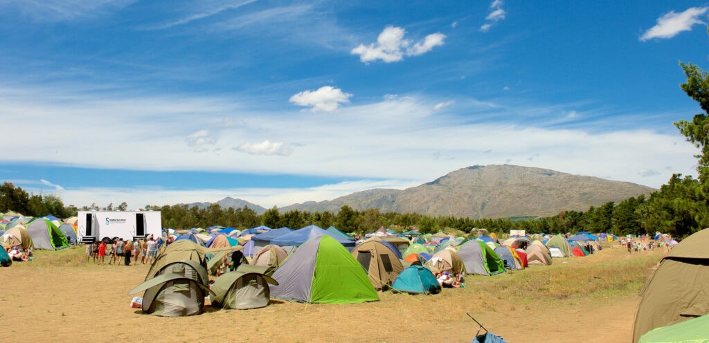 Outdoor camping festival with mountain background