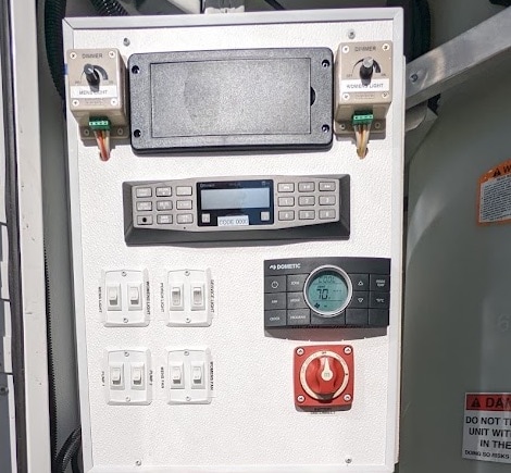 Industrial control panel with switches and display.