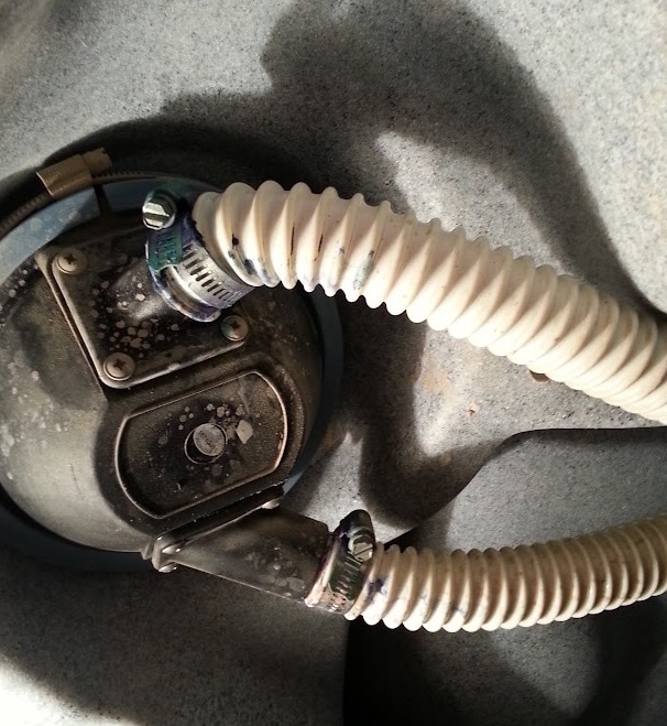 Vintage gas mask with hose on concrete.