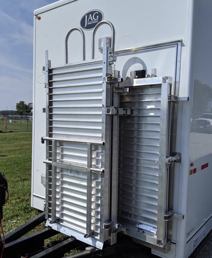 Aluminum ladder on a portable restroom trailer.