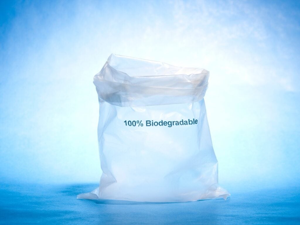 Biodegradable plastic bag on blue background.