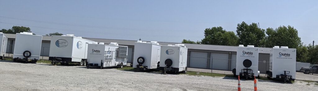 Stahla mobile restroom trailers parked in lot.