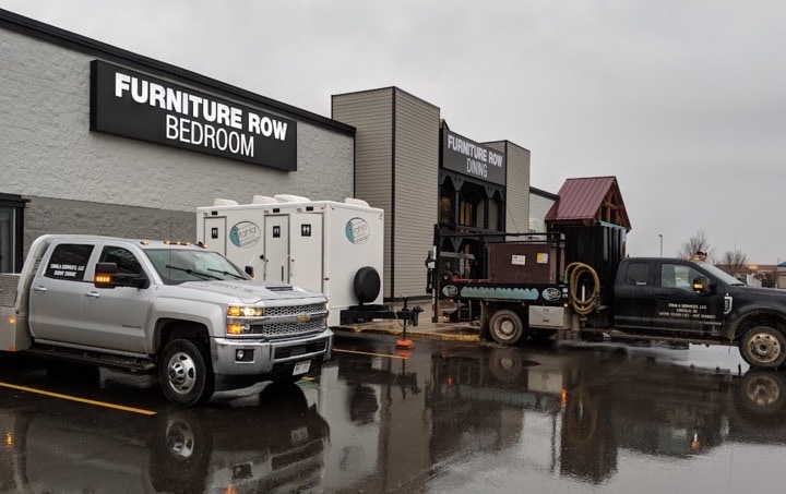 Furniture store with trucks outside on rainy day