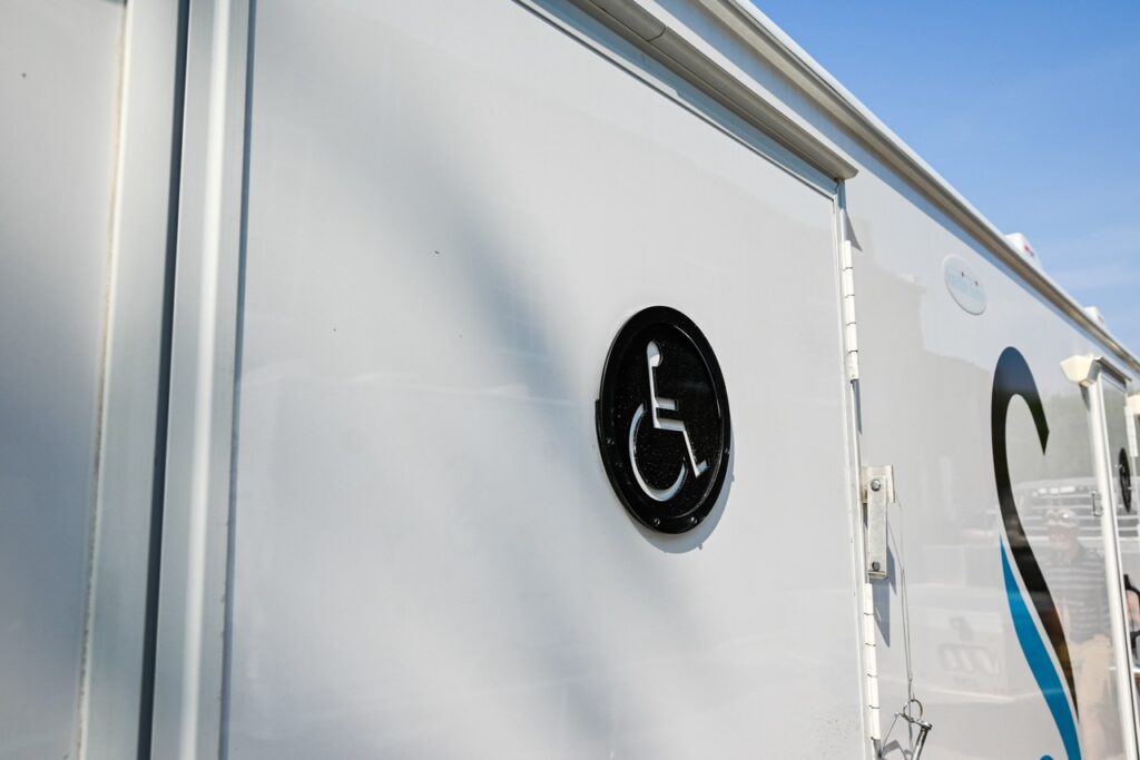 close up of a white wall with a black and white handicap accessibility symbol indicating access, ensuring comfort and tradition.