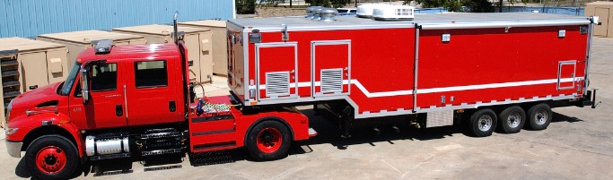 Red fire department support vehicle parked outside.