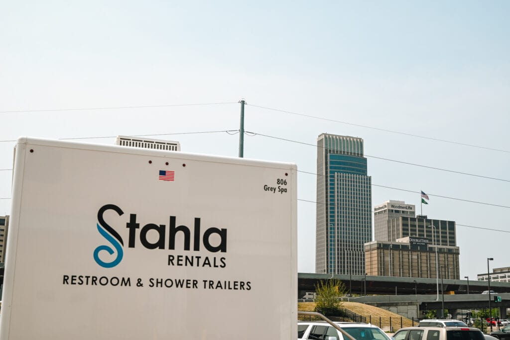 Mobile restroom trailer in urban setting.