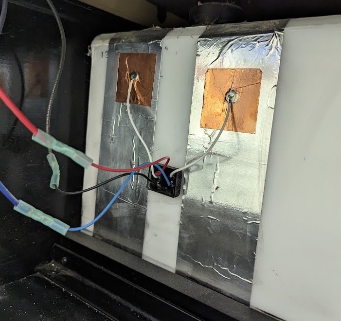 Electrical wiring with copper tape on insulated ductwork.