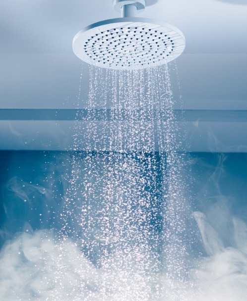 Running water from showerhead with steam.