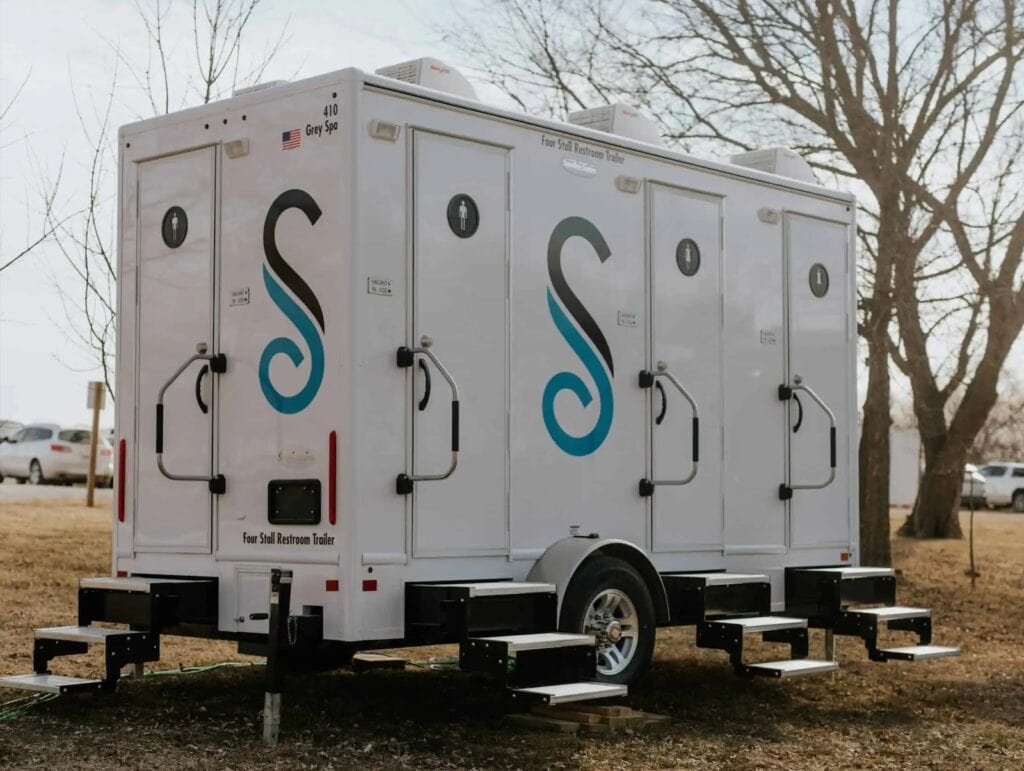 Mobile restroom trailer by Stahla Services parked outdoors.