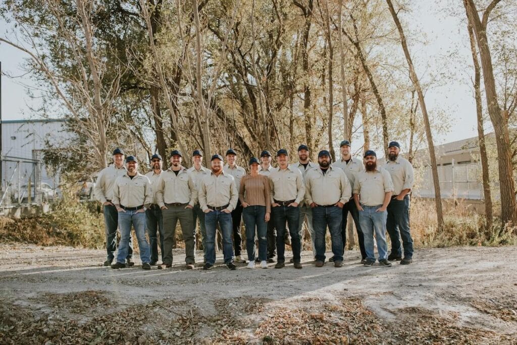 Team of workers outdoors in uniform.
